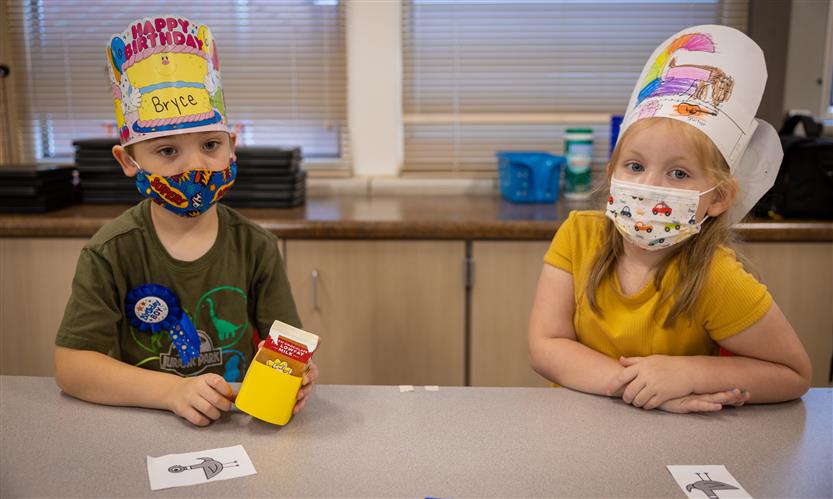 Two students sit at a table
